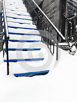 Townhouse staircase covered in snow