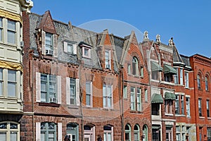 Townhouses with gables and brownstone trim