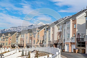 Townhouses on a winter residential landscape with snowy mountain peak background