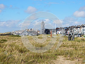 Townscape Katwijk aan Zee with Church, dwellings and dunes with grass photo