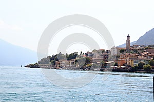 Townscape panorama of lakeside village Limone sul garda with boats and church at Lake Garda