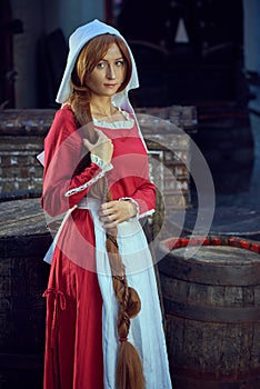 Townswoman in red dress with an apron and chaperone on the street. photo