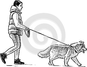A townswoman strolls with her dog photo