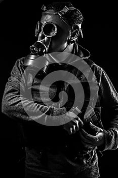 Toxic attack. A man in a gas mask in the smoke. artistic background