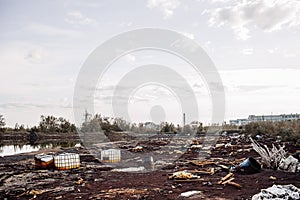 Toxic containers and garbage lying on chemical contaminated wast