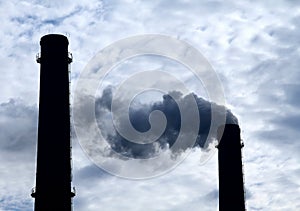 Toxic smoke pollution from smokestack over cloudy sky