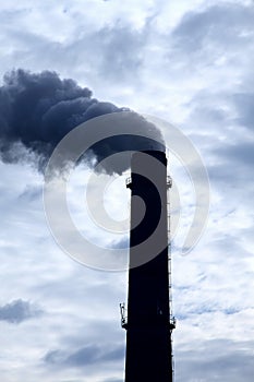Toxic smoke pollution from smokestack over cloudy sky