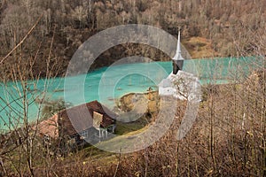 Toxic waste waters from a copper and gold mine submerge village. Abandoned orthodox church on lakeside