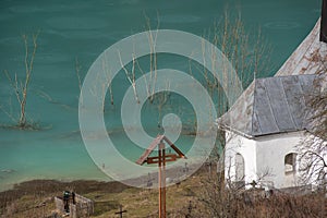 Toxic waste waters from a copper and gold mine submerge village. Abandoned orthodox church on lakeside