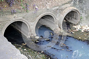 Toxic water running from sewers in dirty underground sewer for dredging drain tunnel cleaning.