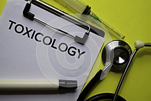 Toxicology on the Document with yellow background. Healthcare or Medical concept photo