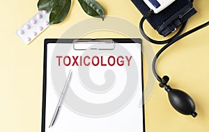 Toxicology on the Document with yellow background. photo