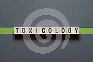 Toxicology - word concept on cubes