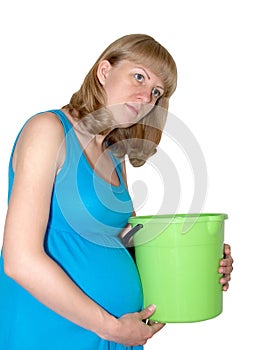 Toxicosis. The pregnant woman holds a plastic bucket
