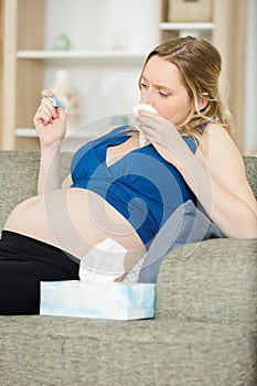 Toxicosis - pregnant woman lies on sofa photo