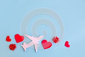 Toy airplane on blue table with red heart