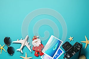 Toy airplane, camera, Santa Claus and photos with beautiful places to relax. Christmas holiday concept with copy space