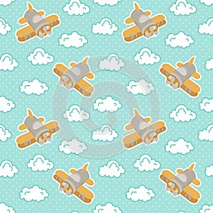 Toy airplanes among fluffy clouds on a blue background with white polka dots