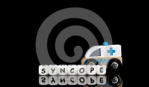 a toy ambulance and a word syncope photo