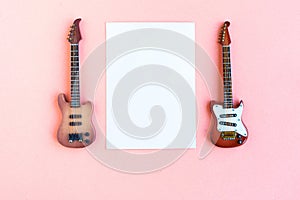 Toy bass and electric guitars and white mockup blank on pink background