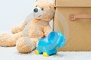 Toy bear and clockwork elephant with brown textile box with hand