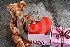 Toy bear doll and the jewelry ring with red heart