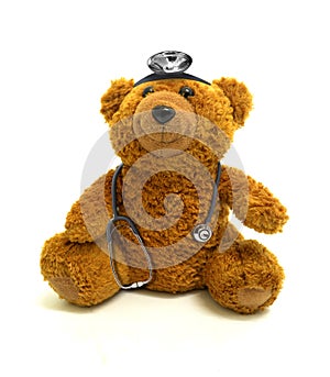 Toy bear with stethoscope and headlamp photo