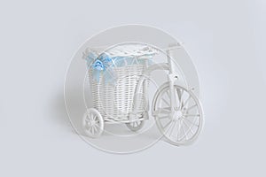 Toy bike with basket on white background. The concept of props