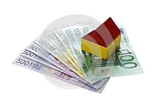 Toy blocks house on euro money, household and financing concept
