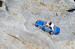 Toy blue police car on stone closeup