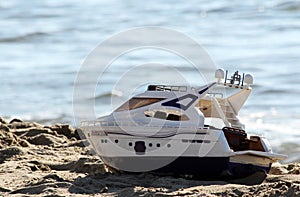 Toy boat on the beach