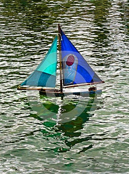Toy Boat on Pond vertical
