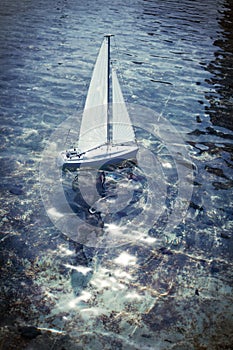 Toy boat sailing on a pond