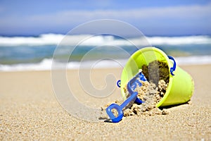 Toy bucket and shovel on an empty beach