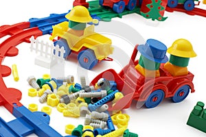 Toy bulldozer and railway on white background