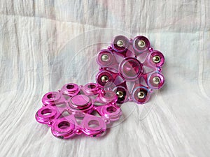 A toy called spinner is purple in color with a unique shape