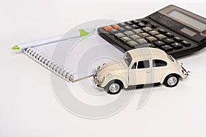 Toy car and calculator with calculations, the concept of selling and buying car