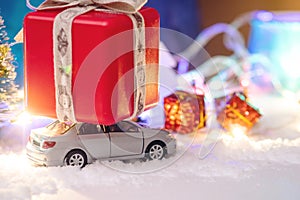 Toy car carries gifts in the Christmas and new year's eve. Concept of holiday shopping and discounts