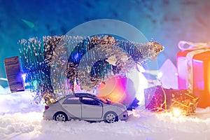 Toy car carries gifts in the Christmas and new year's eve. Concept of holiday shopping and discounts