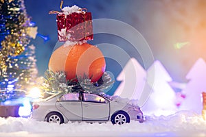 Toy car carries gifts in the new year. The concept of the Christmas mood