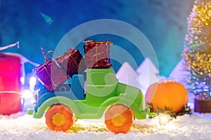 Toy car carries gifts in the new year. Concept of the Christmas mood