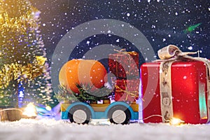 Toy car carries gifts in the new year. The concept of the Christmas mood