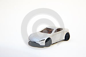 Toy car . Collectible toy model silver sport car . Closeup of a silver baby car on a white background