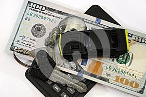 Toy car, dollars, calculator. White background. Business concept. Saving money to buy a car.