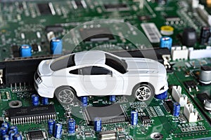 Toy car on electronic board and microchip. Conceptual image for semiconductor shortage disrupting production of the automotive ind photo