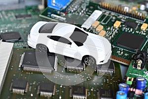 Toy car on electronic board and microchip. Conceptual image for semiconductor shortage disrupting production of the automotive ind photo