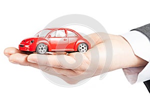 Toy car in the hand of business man concept for insurance, buying, renting, fuel or service and repair costs