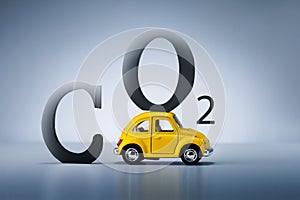 Toy car with letters CO2 on grey background