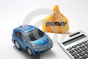 Toy car, money, calculator, and notebook