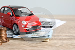 Toy car and money on table, space for text